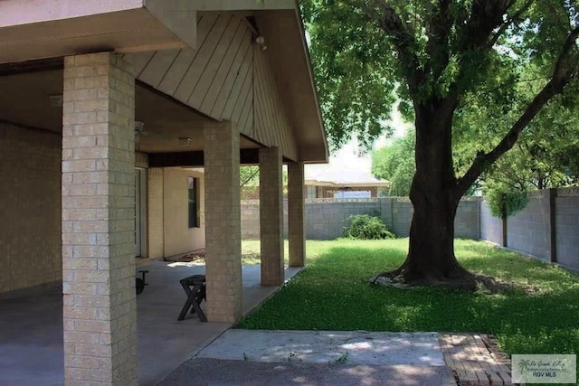 122 Regency Ct, Harlingen, TX 78550 - fenced backyard with a patio