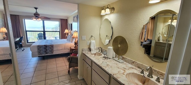 406 Padre Blvd Unit 401, South Padre Island, TX 78597 - bathroom with ensuite bath, a textured wall, a ceiling fan, tile patterned flooring, and double vanity