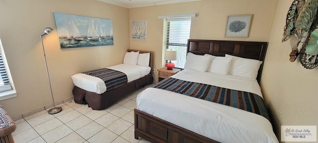 406 Padre Blvd Unit 401, South Padre Island, TX 78597 - bedroom featuring light tile patterned flooring and crown molding