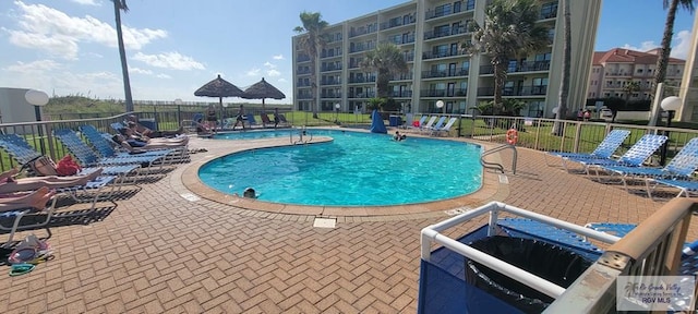 406 Padre Blvd Unit 401, South Padre Island, TX 78597 - community pool featuring a patio and fence