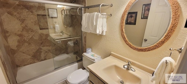 406 Padre Blvd Unit 401, South Padre Island, TX 78597 - full bathroom featuring a textured wall, toilet, vanity, and shower / bath combination with glass door