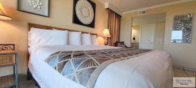 406 Padre Blvd Unit 401, South Padre Island, TX 78597 - tiled bedroom with ornamental molding and a textured wall