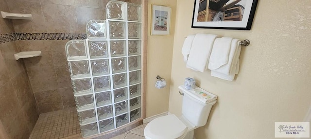 406 Padre Blvd Unit 401, South Padre Island, TX 78597 - bathroom with walk in shower, toilet, and tile patterned flooring