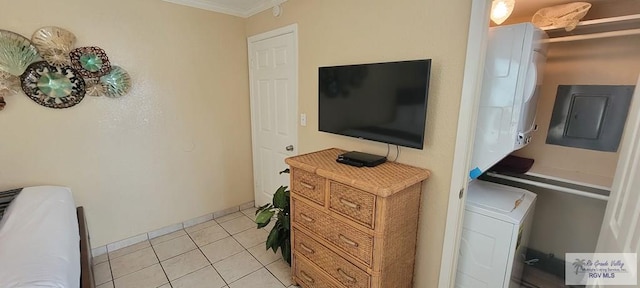 406 Padre Blvd Unit 401, South Padre Island, TX 78597 - bedroom with ornamental molding, light tile patterned floors, and electric panel