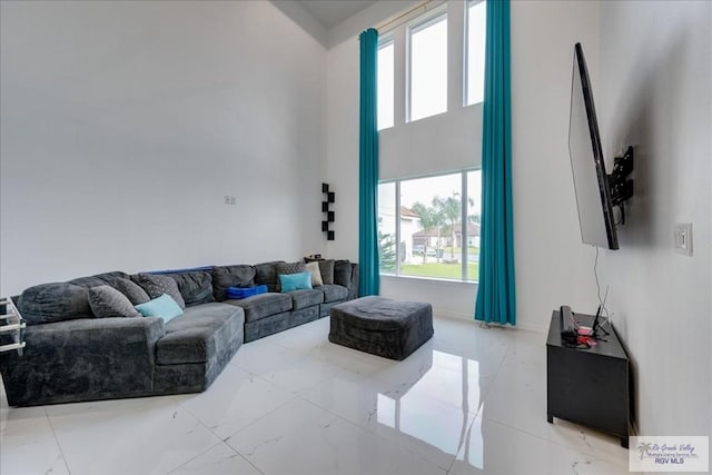 3213 E Westgate Cir, Harlingen, TX 78552 - living room with healthy amount of natural light, baseboards, and a towering ceiling