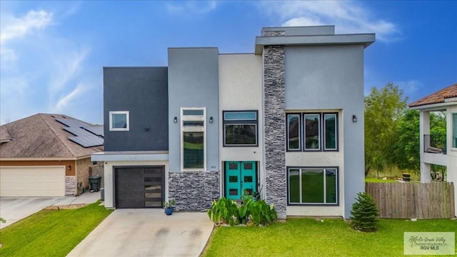 3213 E Westgate Cir, Harlingen, TX 78552 - modern home featuring stone siding, stucco siding, driveway, and a garage