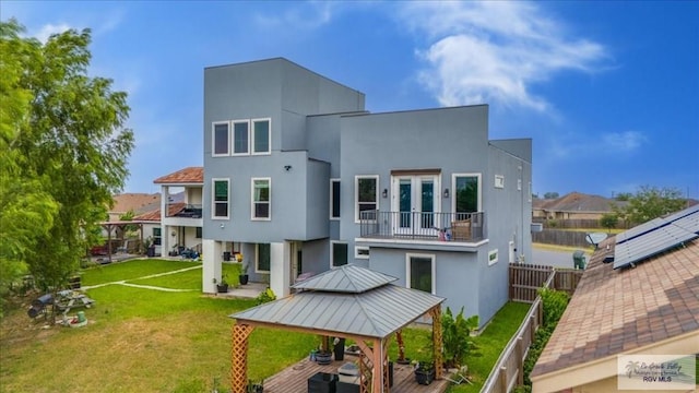 3213 E Westgate Cir, Harlingen, TX 78552 - back of house with a balcony, a gazebo, stucco siding, a residential view, and french doors