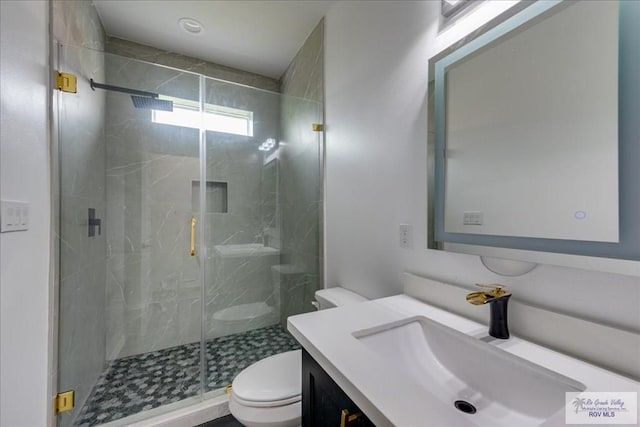 3213 E Westgate Cir, Harlingen, TX 78552 - bathroom featuring toilet, a stall shower, and vanity