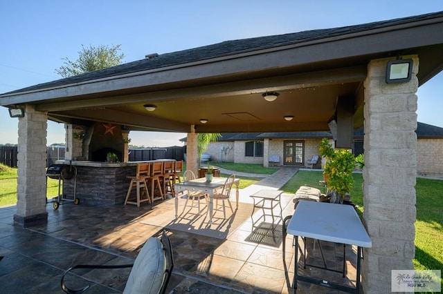 view of patio featuring exterior bar and a gazebo