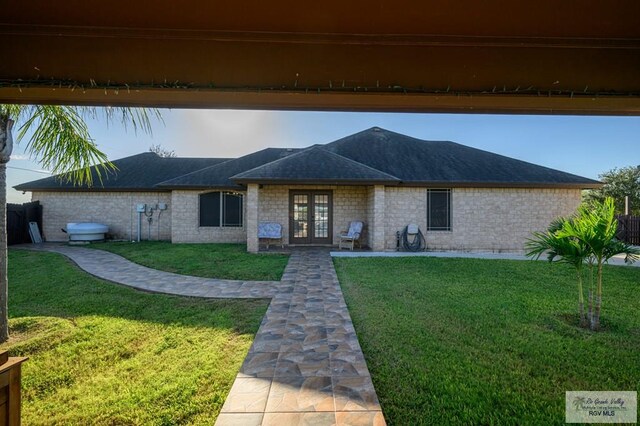 view of front of home featuring french doors and a front lawn