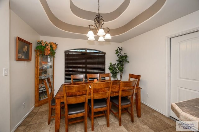 dining space featuring a chandelier and a tray ceiling