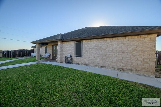 view of property exterior with a lawn