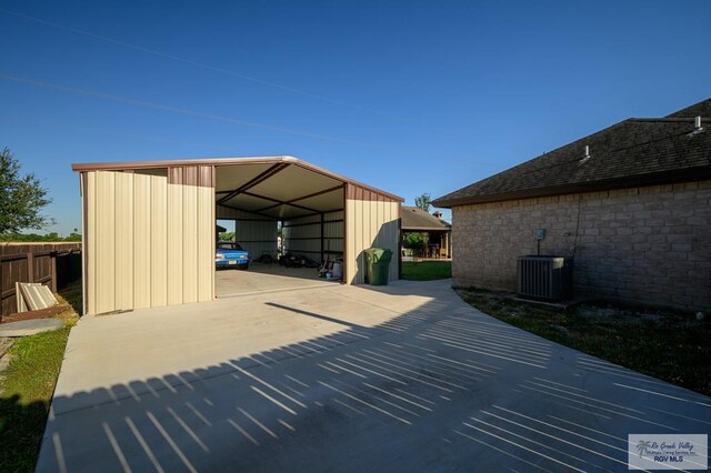 exterior space with central air condition unit and a carport