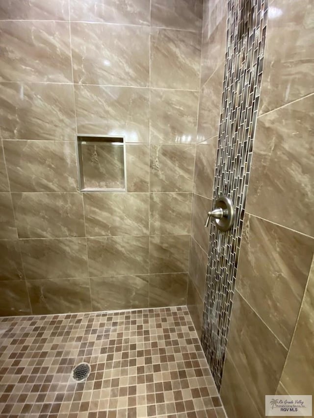 bathroom with a tile shower