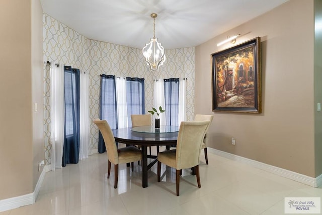 dining space featuring light tile patterned floors and an inviting chandelier