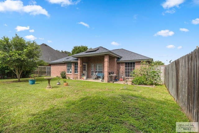 2518 Thomas Ln, Harlingen, TX 78550 - back of house featuring brick siding, a patio, and roof with shingles