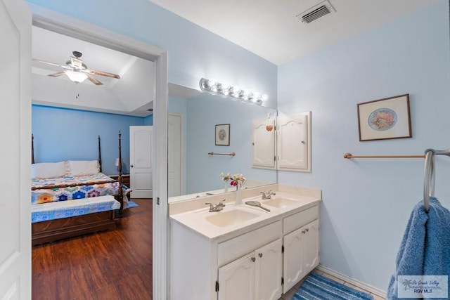 2518 Thomas Ln, Harlingen, TX 78550 - ensuite bathroom featuring double vanity, wood finished floors, and ceiling fan