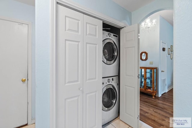 2518 Thomas Ln, Harlingen, TX 78550 - laundry room with stacked washer and clothes dryer and light wood finished floors