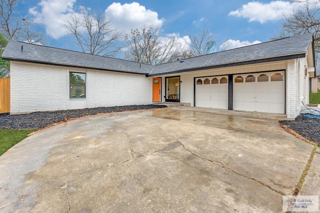 ranch-style house featuring a garage