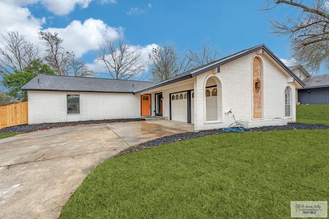 ranch-style home featuring a garage and a front yard