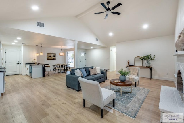 living room with beamed ceiling, ceiling fan, high vaulted ceiling, and light wood-type flooring