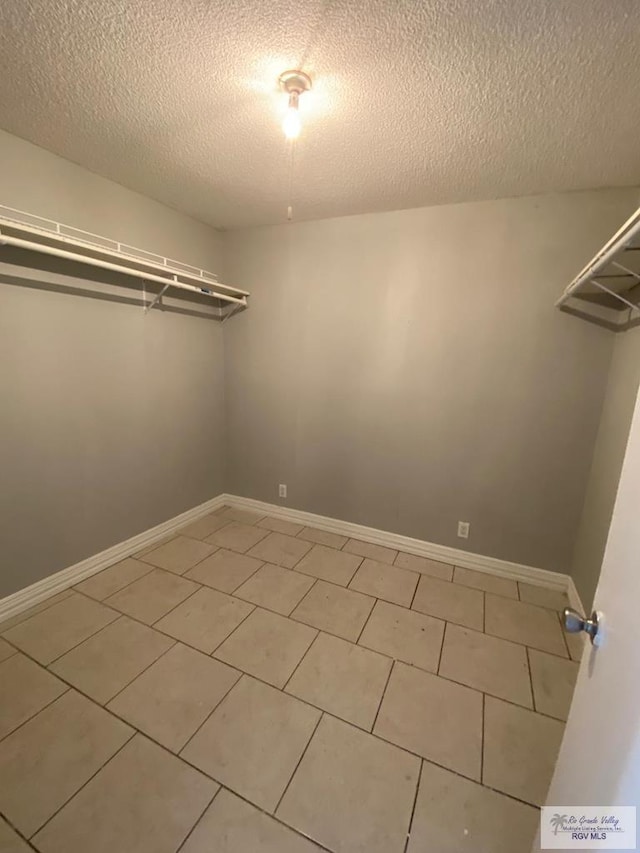 spacious closet featuring tile patterned flooring