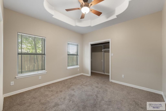 5302 Remington Dr, Harlingen, TX 78552 - unfurnished bedroom with a tray ceiling, carpet, a closet, and ceiling fan