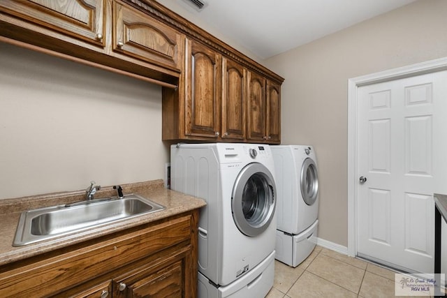 5302 Remington Dr, Harlingen, TX 78552 - washroom featuring cabinet space, washing machine and dryer, and light tile patterned flooring