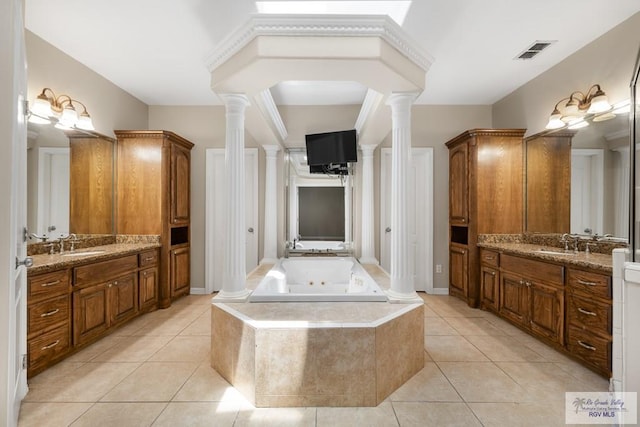 5302 Remington Dr, Harlingen, TX 78552 - bathroom featuring ornate columns, tile patterned floors, a whirlpool tub, and two vanities