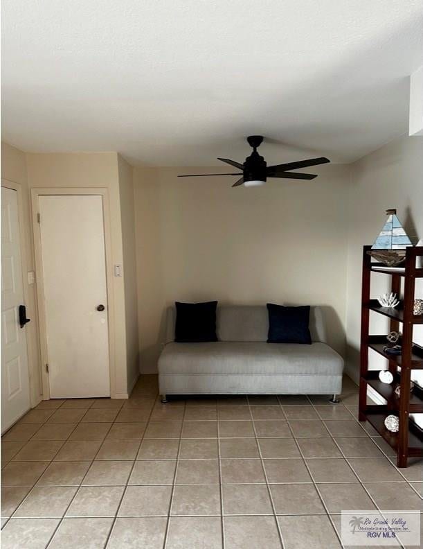 unfurnished living room with light tile patterned floors and ceiling fan