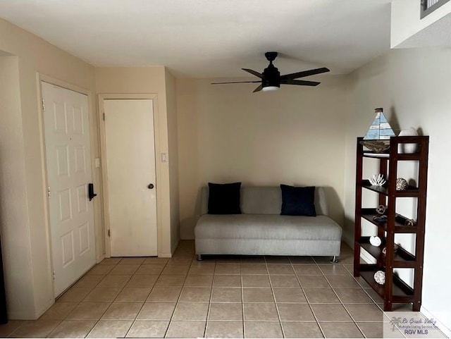 unfurnished room with ceiling fan and light tile patterned floors