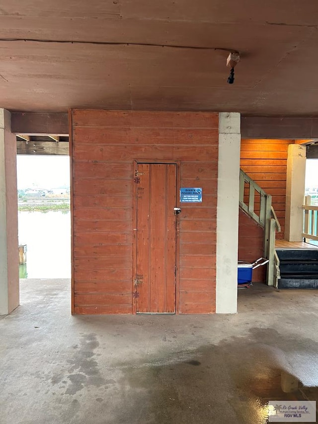 garage featuring wood walls