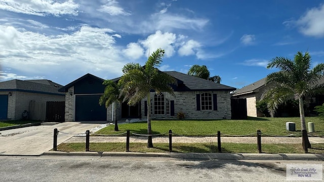 ranch-style home featuring a garage and a front yard