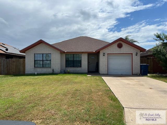 single story home featuring a garage and a front lawn