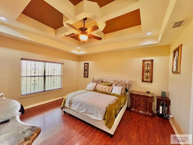 bedroom featuring dark hardwood / wood-style floors, a raised ceiling, ceiling fan, and coffered ceiling