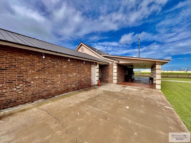 view of home's exterior featuring a yard and a carport