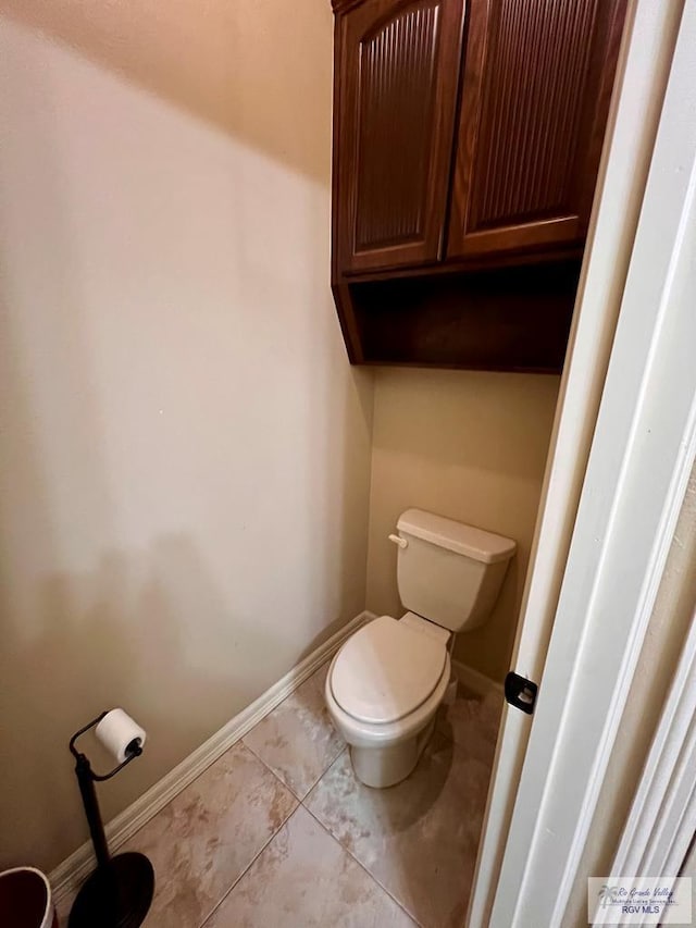 bathroom with tile patterned floors and toilet