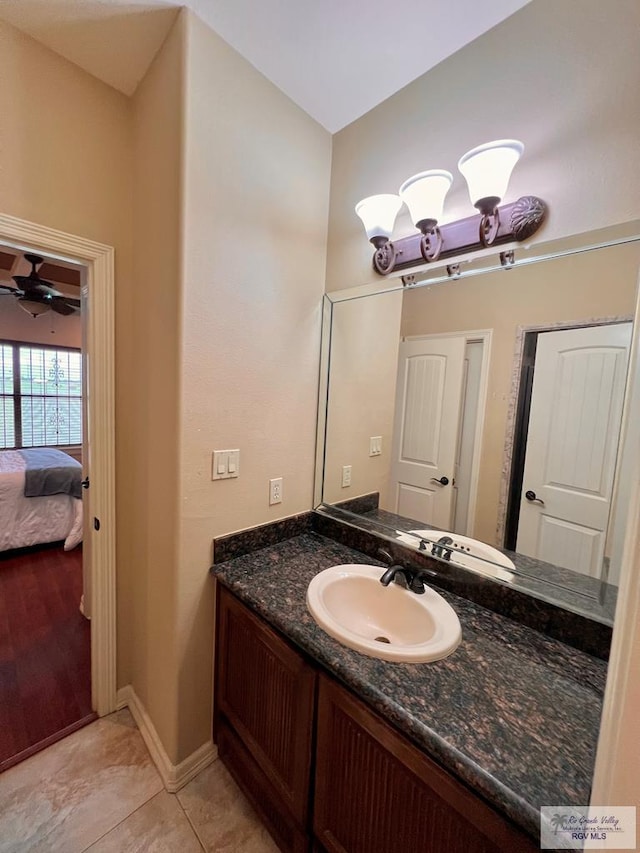 bathroom with ceiling fan, tile patterned flooring, and vanity