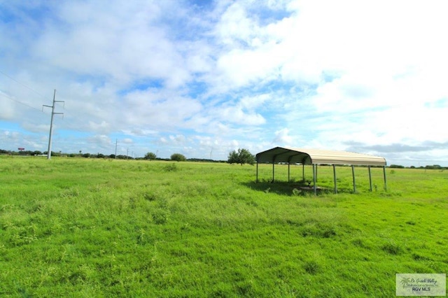 view of yard featuring a rural view and a carport