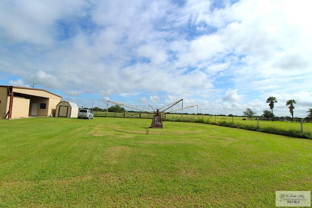 view of yard featuring a rural view and an outdoor structure