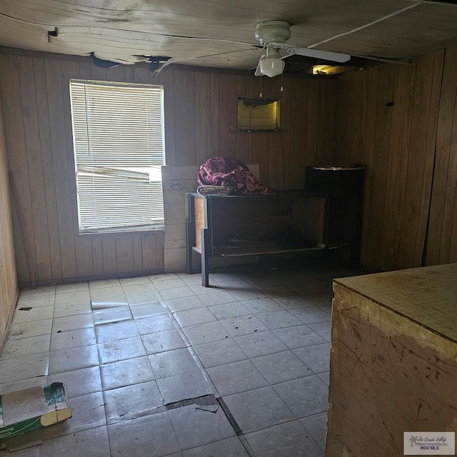 1130 N Sunset Dr, Harlingen, TX 78550 - dining area with wooden walls, a ceiling fan, and light tile patterned floors