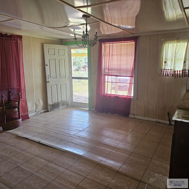 1130 N Sunset Dr, Harlingen, TX 78550 - tiled entrance foyer featuring a chandelier and wooden walls