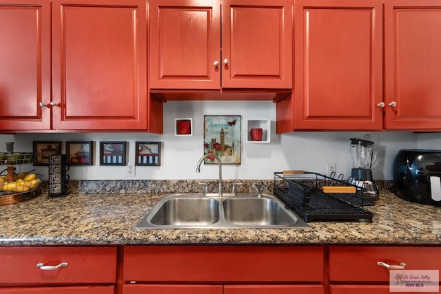 kitchen featuring sink and stone countertops