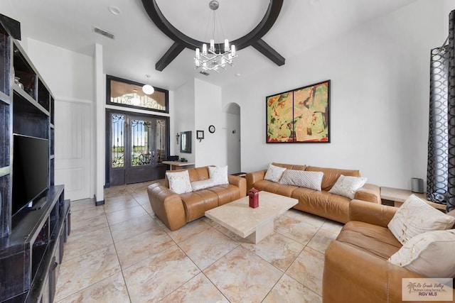 tiled living room featuring a notable chandelier