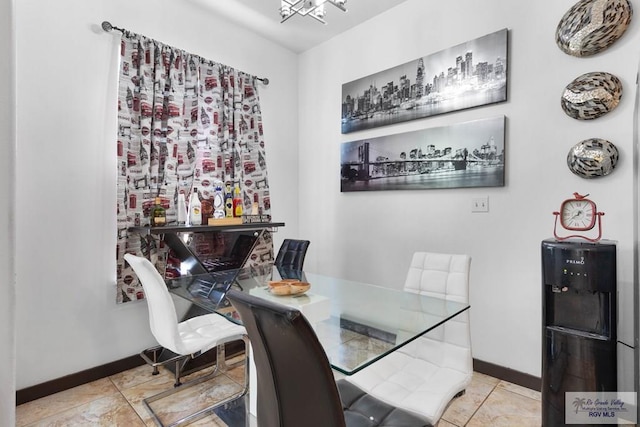 tiled dining space featuring a notable chandelier