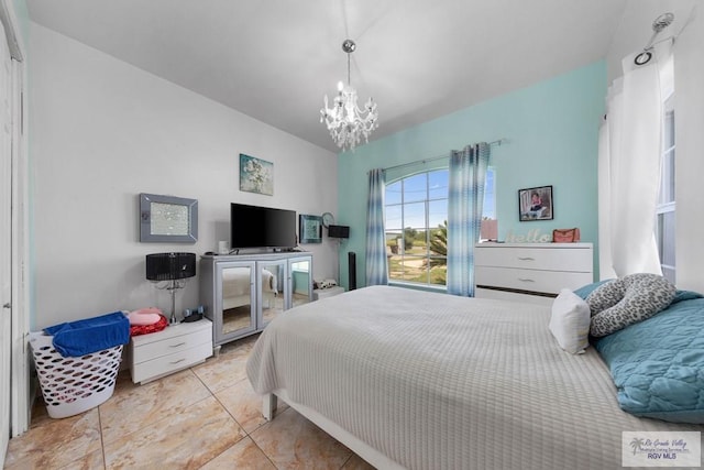 tiled bedroom featuring a notable chandelier