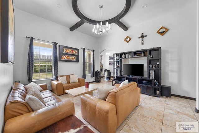 living room with light tile patterned floors and an inviting chandelier