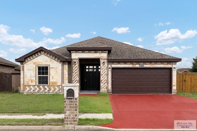 view of front of house with a front yard and a garage