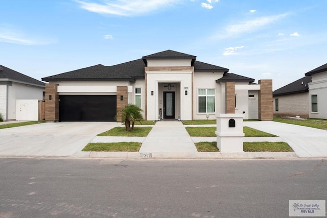 9073 New Orleans Ct, Los Fresnos, TX 78566 - view of front of property with a garage, concrete driveway, stucco siding, and a shingled roof