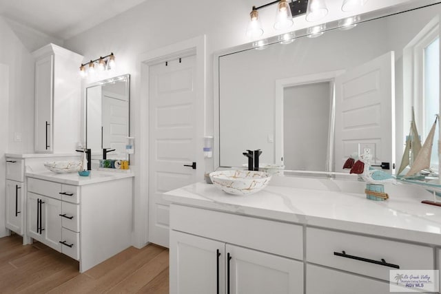 9073 New Orleans Ct, Los Fresnos, TX 78566 - bathroom featuring wood finished floors and vanity